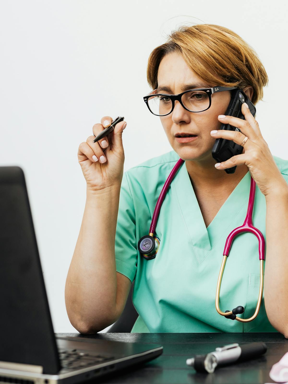Doctor using software on a laptop in a clinical setting